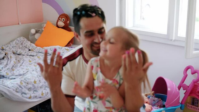Daughter and father role-playing manicure salon