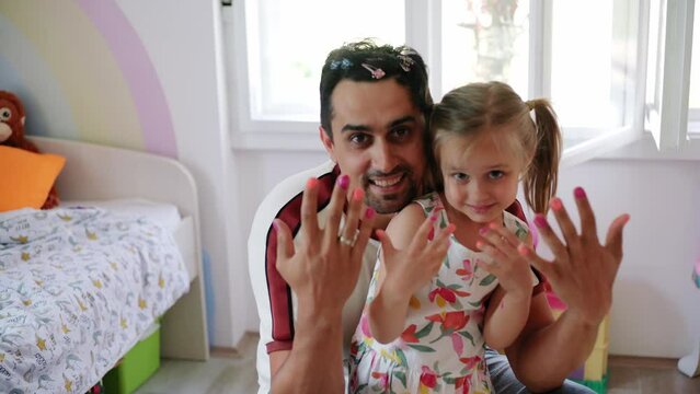 Daughter and father role-playing manicure salon