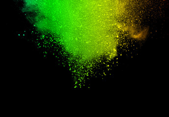 Abstract powder splatted background. Green powder explosion on black background. Colored cloud. Colorful dust explode. Paint Holi