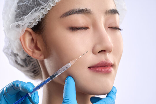 Young women undergoing facial injections in medical beauty plastic surgery