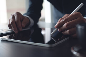 Close up, businessman using stylus pen signing e-document on digital tablet at office, E-signing,...