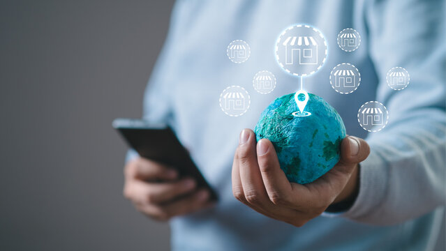 customer hand hold world online shopping concept, marketplace website with virtual interface of online Shopping cart part the network, Online shopping business with selecting shopping cart.