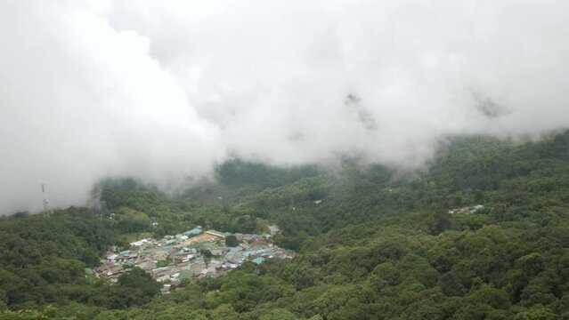 aerial view from doi pui view point to the local village among the mountain range hill valley with white cloud and fog over the village