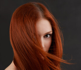 Naklejka premium Woman, portrait or ginger hair care in studio with soft texture, keratin treatment or cosmetics glow. Model, face or natural beauty with salon hairstyle, shampoo growth or results on black background