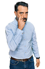 Middle aged man with beard wearing business shirt pointing to the eye watching you gesture, suspicious expression