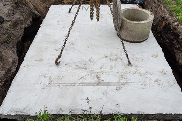 Concrete septic tank with a capacity of 10 m3 located in the garden next to the house, visible...