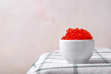 Red caviar served in a small bowl against the white background with copy space - 765747518