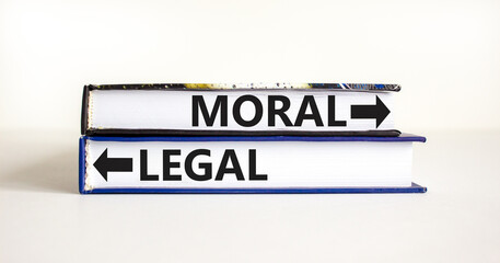 Moral or legal symbol. Concept word Moral or Legal on beautiful books. Beautiful white table white...