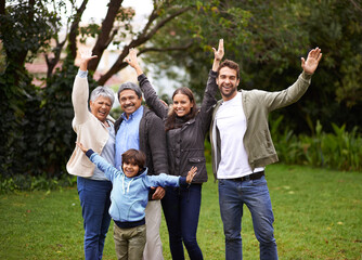 Portrait, smile and big family outdoor for freedom, celebration or laugh together at backyard. Park, happy and child with parents, grandparents and mother with interracial father at garden in nature