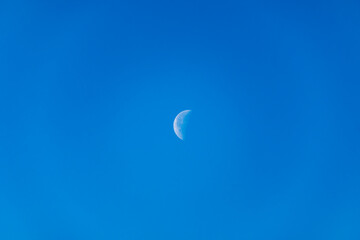 Waning Gibbous moon. A waning gibbous moon is a moon between full and last quarter, over blue sky