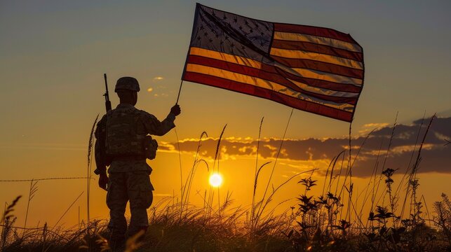 American soldier holding flag at sunrise