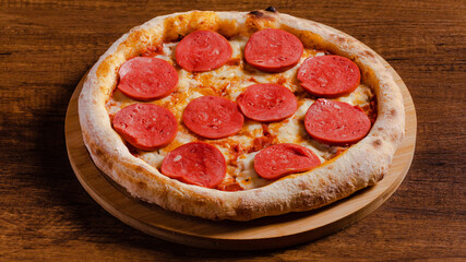 Delicious pizza pepperoni isolated on wooden background