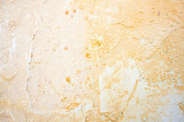 Old,dilapidated peeling plaster on the wall. Surface,background of dried coating on the wall.