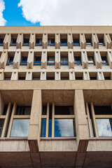 Boston City Hall, the towering, top heavy, brutalist government building on a partly cloudy day.
