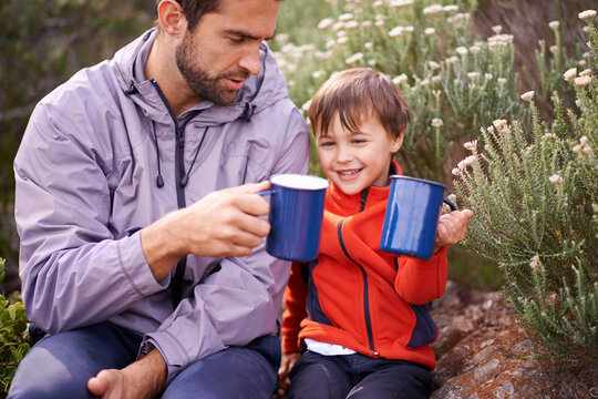 Dad, child and camping mug with smile from hiking, travel and journey in nature with adventure. Backpack, youth and father with love, support and trust together outdoor with drink and cheers for fun - Powered by Adobe
