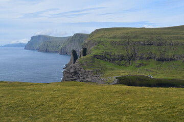 The dramatic coastline and green mountains of the Faroe Islands