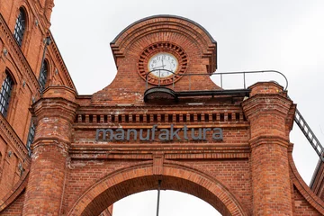 Gordijnen Red brick arch with clock  © Maryia