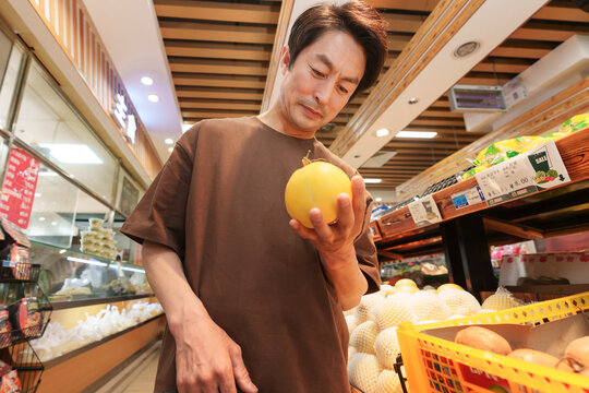 Middle-aged men shopping in the supermarket