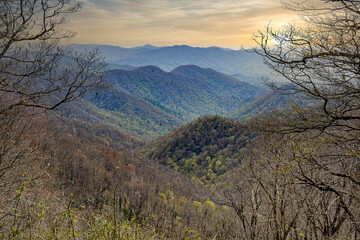 An overlook of the Great Smoky Mountains during early spring, before many of the trees have leafed out. The mountains are beginning to green as the landscape transitions from winter to spring.