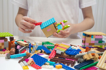 Fototapeta premium 8 year old child collects Lego