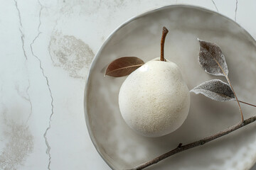 frozen pear covered with frost on white plate in minimal kitchen