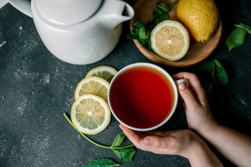 Glass cup with hot tea and lemon on table