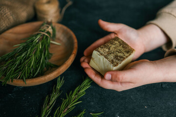 Natural solid shampoo with rosemary in hands