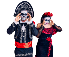 Young couple wearing mexican day of the dead costume over background with hand on head, headache because stress. suffering migraine.