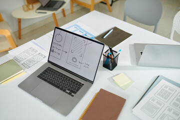 Laptop with mobile application wireframe on screen