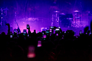 Fototapeta na wymiar Hands with phones on concert, atmosphere on concert