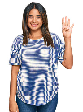 Young latin girl wearing casual clothes showing and pointing up with fingers number four while smiling confident and happy.