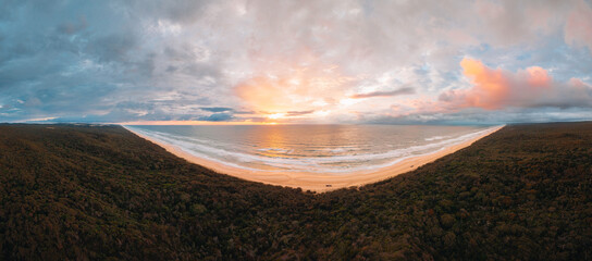High angle aerial drone view of famous Seventy Five Mile Beach, 75 mile beach on Fraser Island, Kgari, Queensland, Australia, shortly before sunset - obrazy, fototapety, plakaty