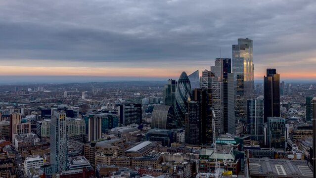 Day to night time lapse view of the City of London, England, with the skyline and skyscrapers and Tower Bridge in the background