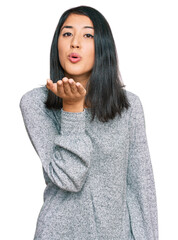 Beautiful asian young woman wearing casual clothes looking at the camera blowing a kiss with hand on air being lovely and sexy. love expression.