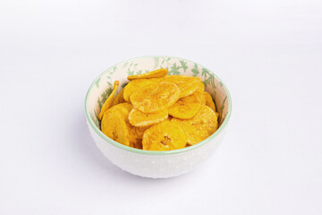 Green banana chips on white background