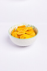 Green banana chips in a bold on white background vertical