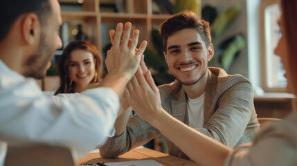 group of professionals in a vibrant office setting, enthusiastically engaging in a team high-five, signifies a moment of celebration or achievement.