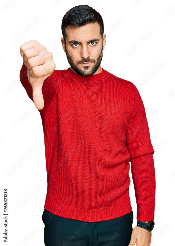 Poster Young hispanic man wearing casual clothes looking unhappy and angry showing rejection and negative with thumbs down gesture. bad expression.