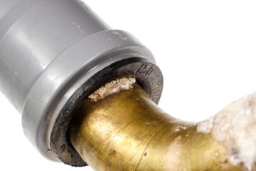 salt deposits on plastic elbow of drain pipe close up isolated on white background