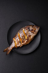 Delicious dorado baked on the grill with salt, spices and herbs