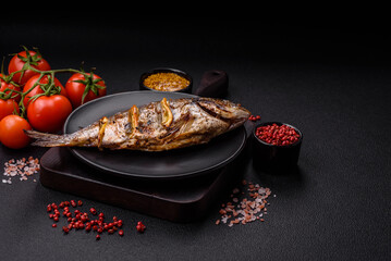 Delicious dorado baked on the grill with salt, spices and herbs