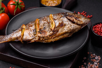 Delicious dorado baked on the grill with salt, spices and herbs