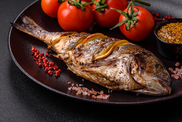 Delicious dorado baked on the grill with salt, spices and herbs