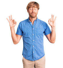 Handsome caucasian man with beard wearing casual clothes relax and smiling with eyes closed doing meditation gesture with fingers. yoga concept.