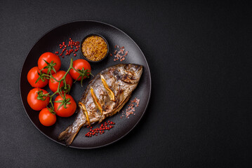 Delicious dorado baked on the grill with salt, spices and herbs