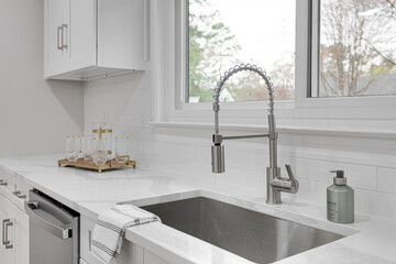 Bright Modern White Kitchen Sink with Styled Décor and Stainless Steel Appliances