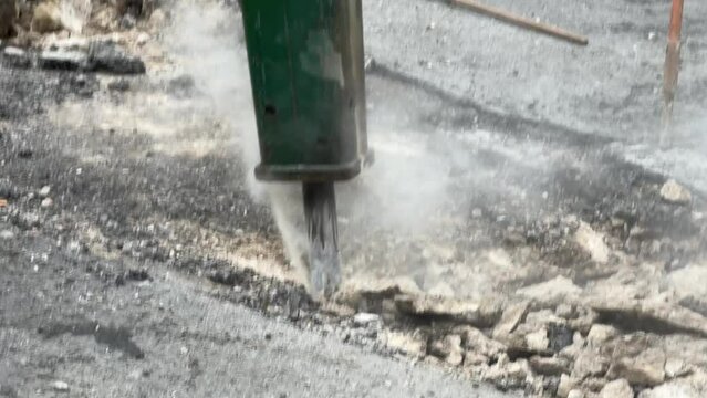 Dismantling of asphalt concrete pavement with pneumatic jackhammer during road works
