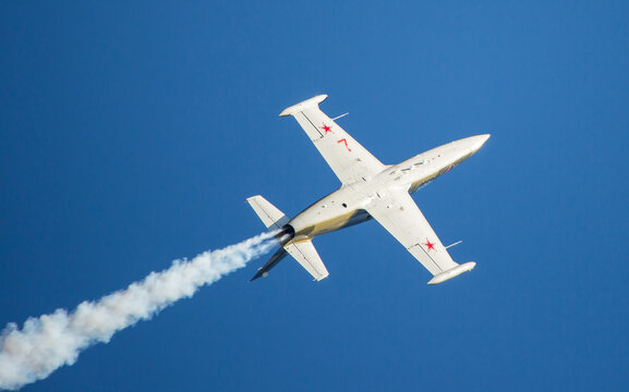 L-39 Albatros Jet Flying Inverted Against Deep Blue Sky