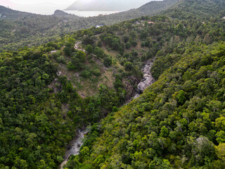 Aerial drone view small Koh Ma island, Ko Phangan Thailand. Exotic coast panoramic landscape, Mae Haad beach, summer day. Sandy path between corals. Vivid seascape, mountain coconut palms from above.