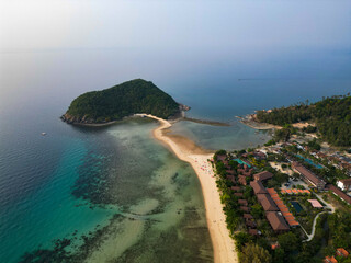 Aerial drone view small Koh Ma island, Ko Phangan Thailand. Exotic coast panoramic landscape, Mae Haad beach, summer day. Sandy path between corals. Vivid seascape, mountain coconut palms from above.